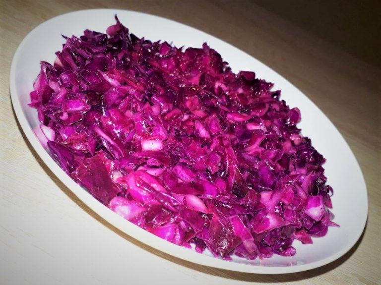 A bowl of red cabbage on a table, perfect for red cabbage recipes.