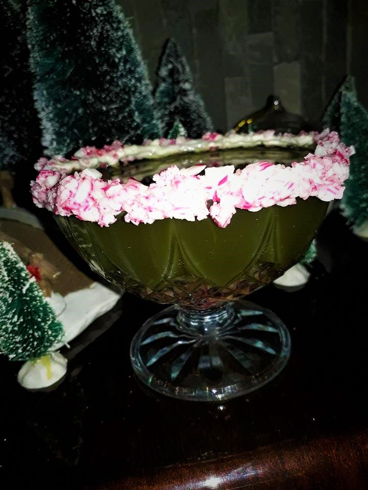 A bowl of green and pink flowers on a table.