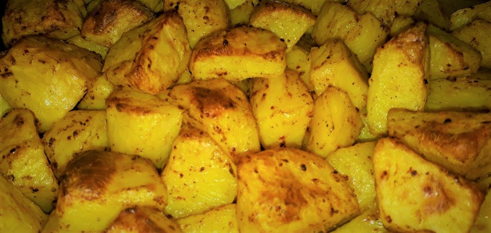 A pile of roasted potatoes in a pan.